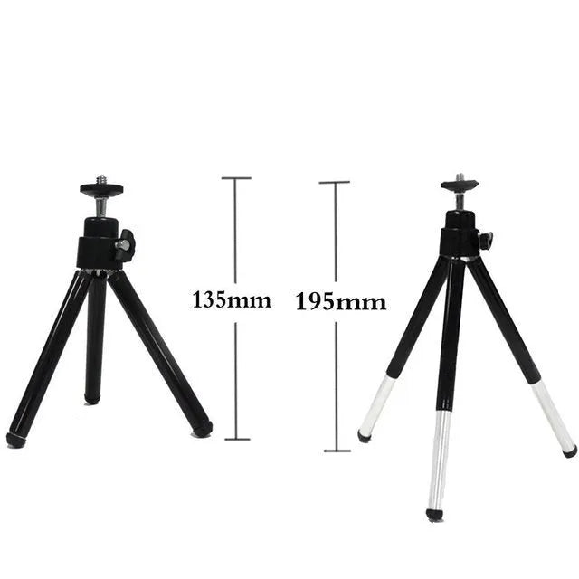 Mini flexible aluminium desktop tripod with ball head extended, alongside a universal U-shaped black phone clip.