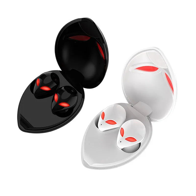 Creative Outer T8 Starman alien design Bluetooth earbuds with LED lights next to wireless charging case.