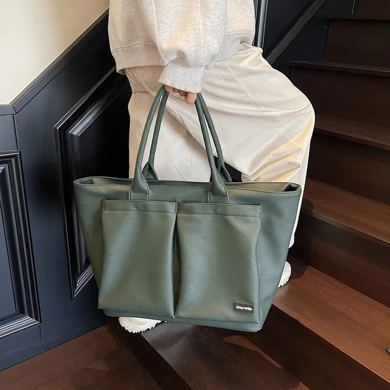 Lightweight PU shoulder bag in black, green, or white with 20-35 litre capacity