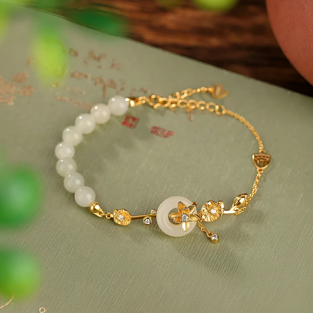 Women's 925 silver bracelet with inlaid Hetian jade centrepiece and ornate lotus peace buckle design.