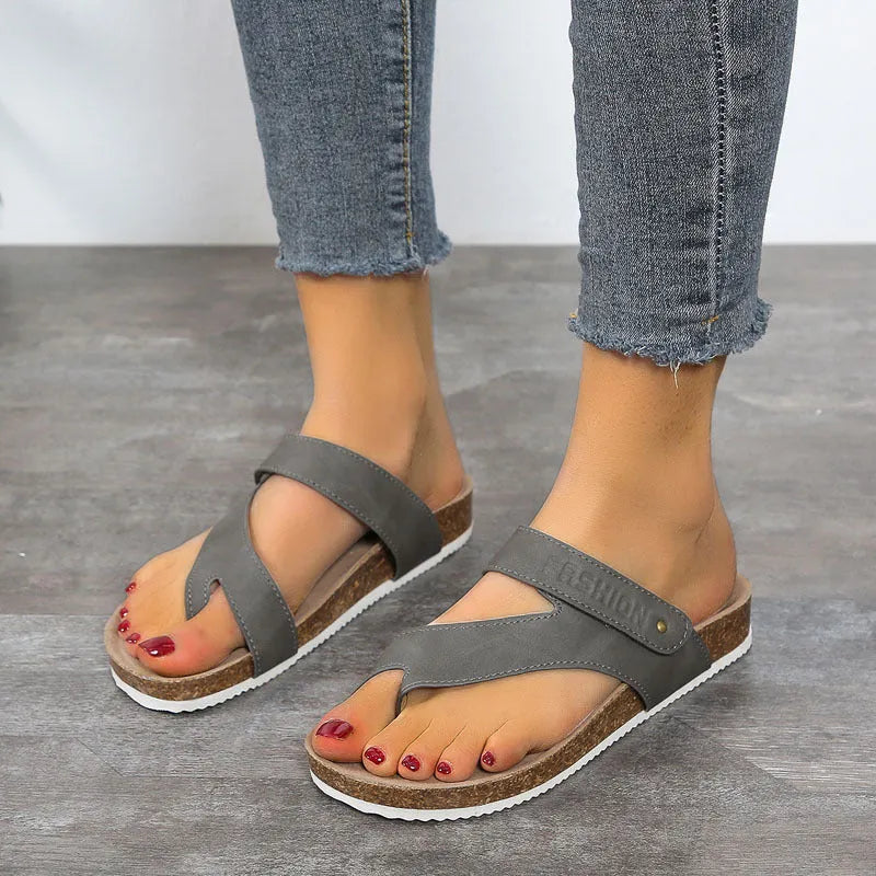 Flat thong sandals with a toe ring and thick foam sole in a solid colour.