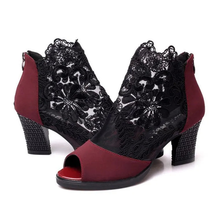 Lucyever women's black gladiator sandals with floral lace upper, square heel, and peep toe on a foot.