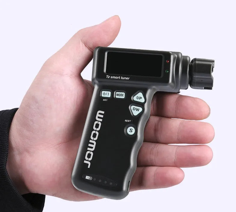Black and white smart guitar tuner with integrated string winder and colour LCD display on a guitar headstock.