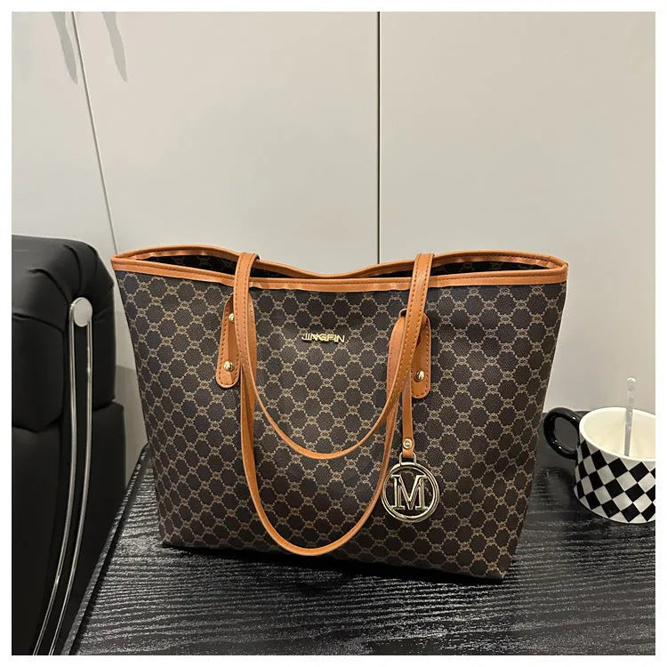 Western style women's shoulder bag in PU leather with contrast stitching, shown in black.