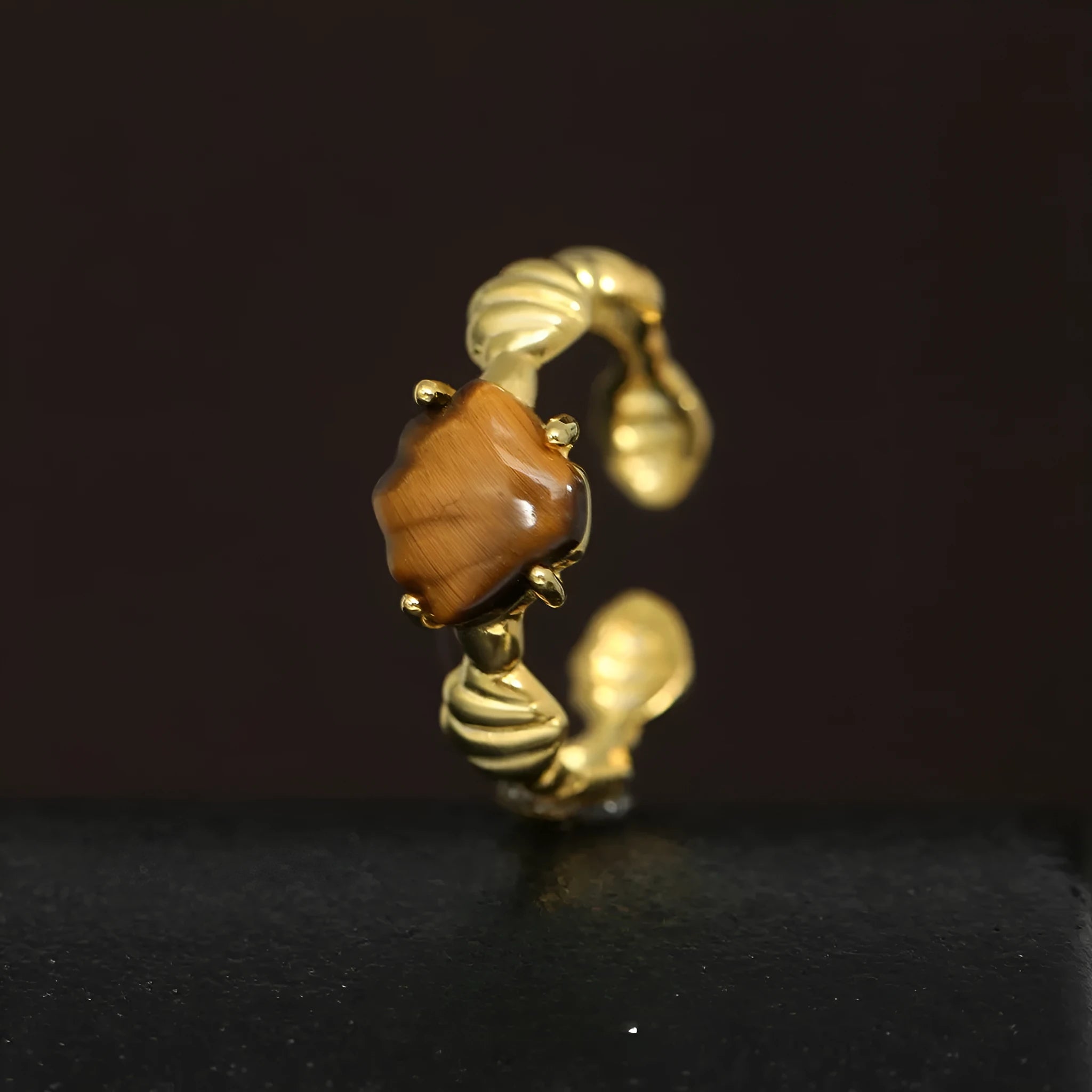 Adjustable silver ring with a white shell and tiger eye stone, featuring an electroplated gold finish.