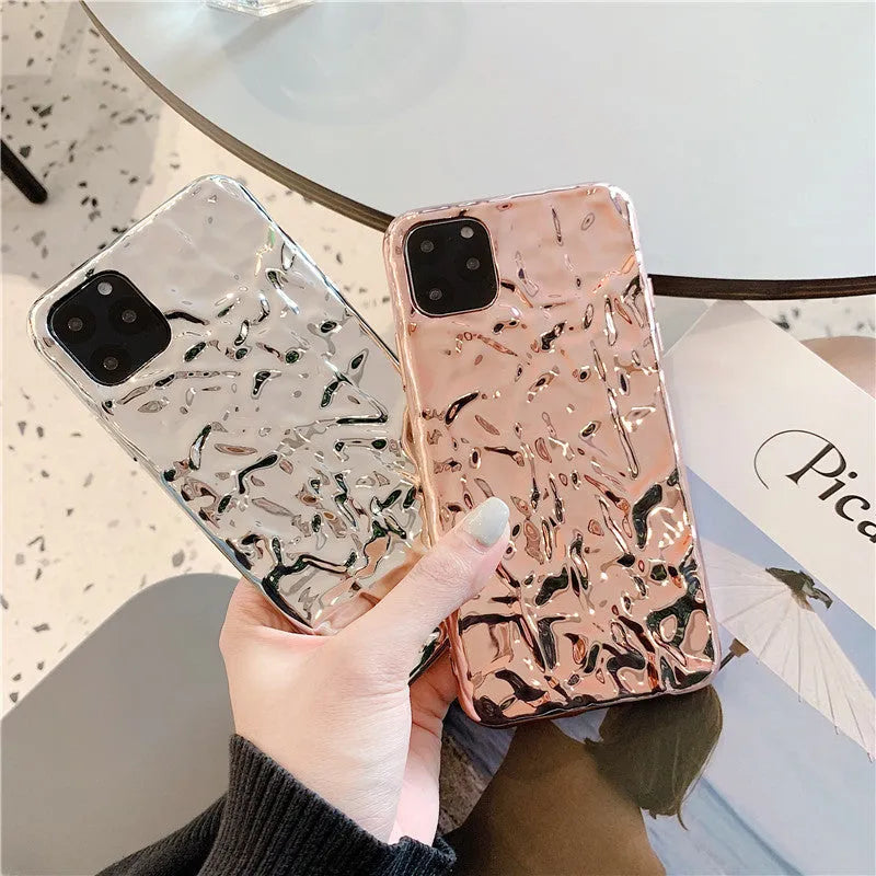 Rose gold and silver coloured TPU back cover cases for iPhone on a plain background.