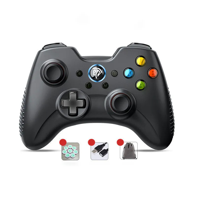 Black dual-mode wireless PC game controller with coloured buttons on a desk next to its storage bag and adapter.