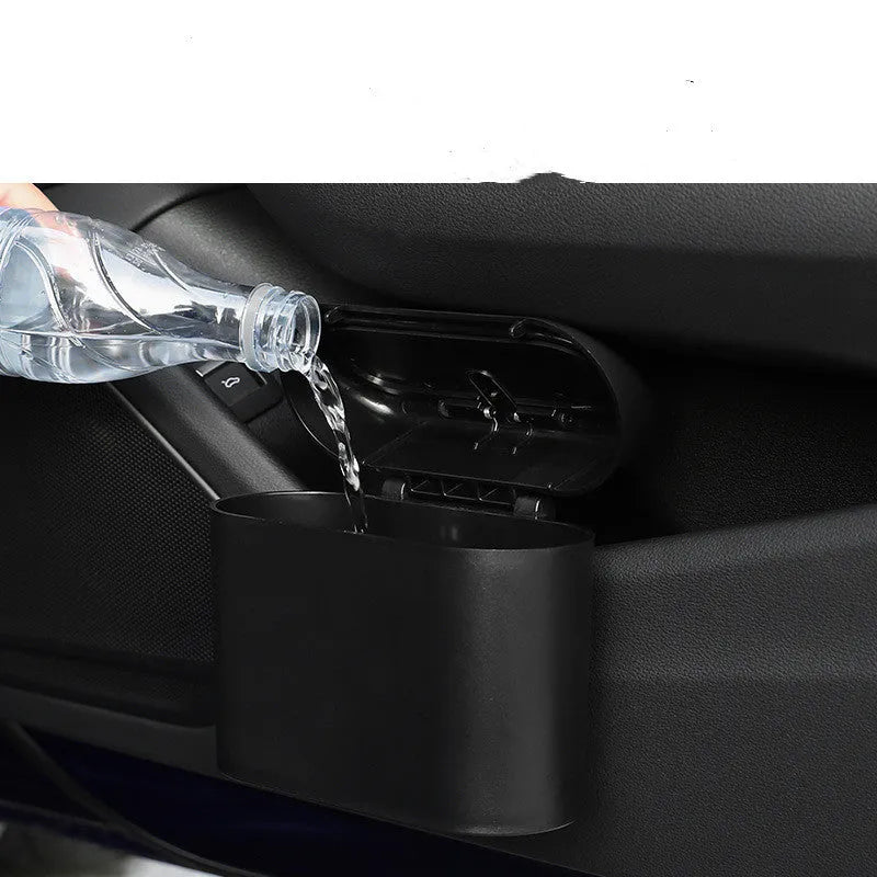 Black ABS plastic car trash can measuring 160x143x85mm with removable hook and upturned lid