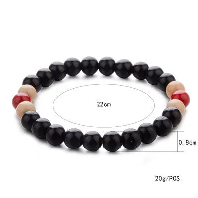Natural stone beaded bracelet with lava stones for essential oils on a wrist.
