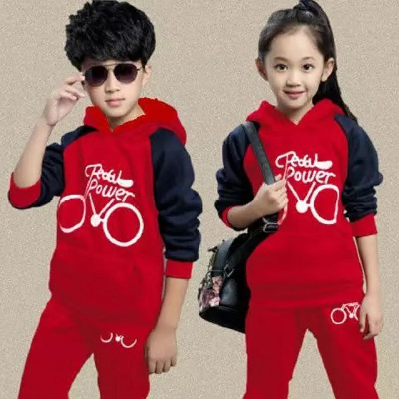 Children's black tracksuit set with printed design, showing jacket and trousers laid flat
