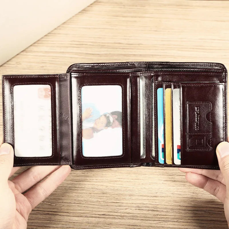 Men's black genuine leather bifold wallet open, showing eight card slots and a zipped coin compartment.