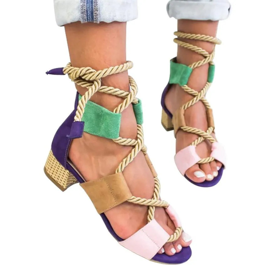 Women's beige suede sandals with a thick middle heel, fish mouth toe, and front ankle straps.