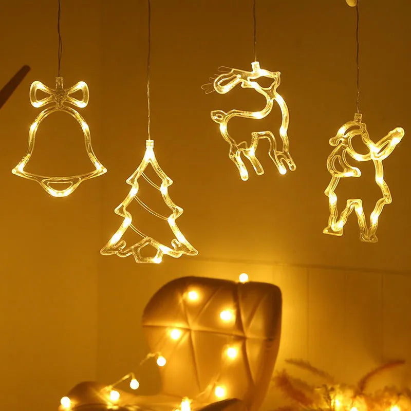 Battery powered LED decorative light with suction cups showing Santa Claus and snowman designs on a window.