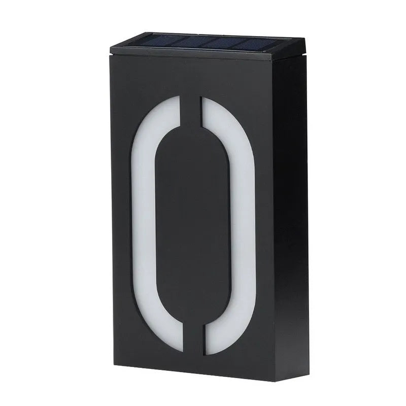 White solar-powered house number light with visible solar panel and LEDs, mounted on a wall.