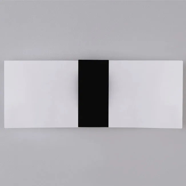 Modern acrylic LED wall lamp in black finish mounted on corridor wall