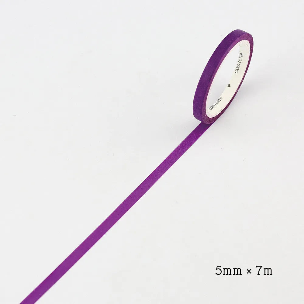 Hand-roll of solid colour paper tape in crimson and deep purple, showing narrow 5mm width.