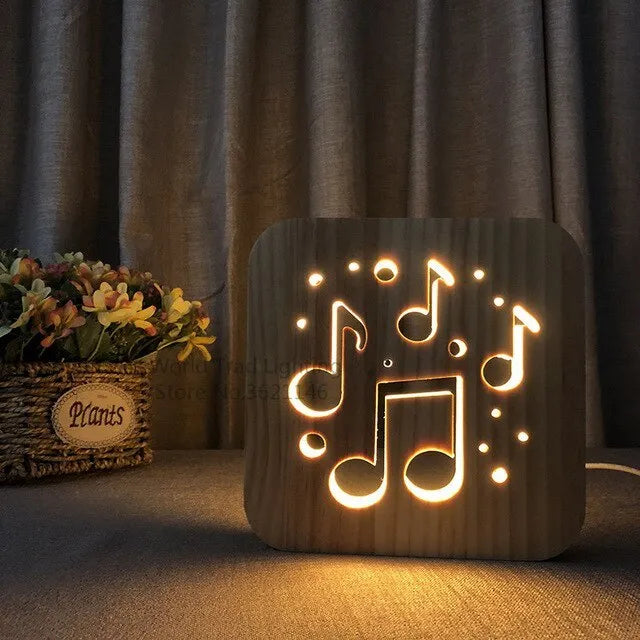 Square pine wood USB lamp with 3D design emitting warm white light on a wooden desk.