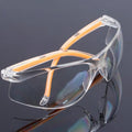 Transparent labour protection safety goggles with yellow frame for industrial and laboratory eye protection
