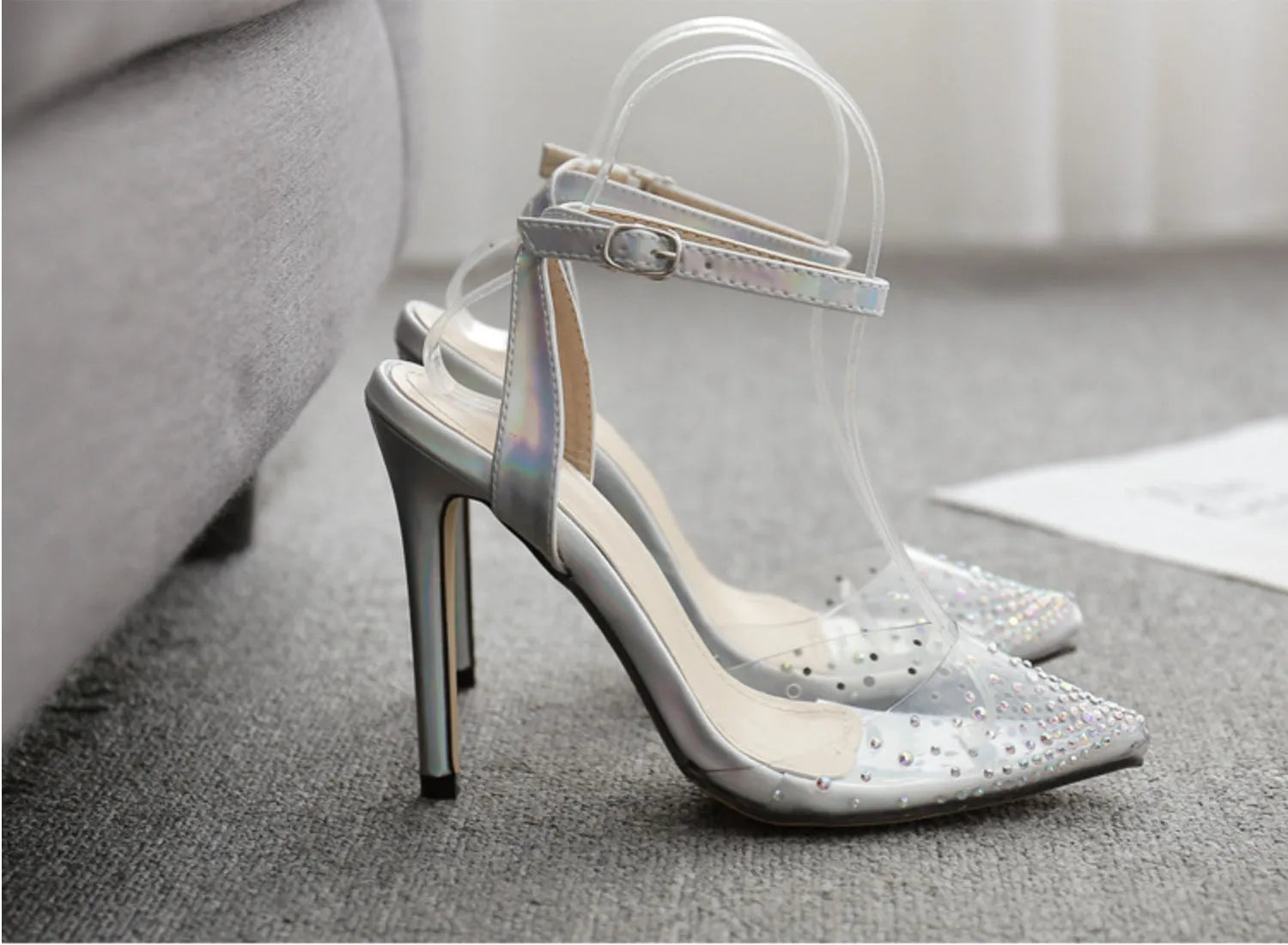 Women's pointed toe stiletto sandals with crystal diamond decoration on a PVC upper.