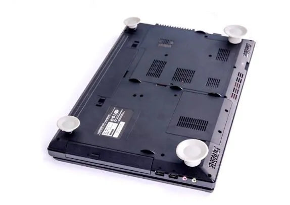 Grey plastic laptop cooling pad set showing two large and two small pads on a wooden desk.