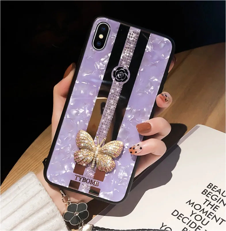 Clear acrylic iPhone case with a sparkling butterfly design and a reflective mirror surface.
