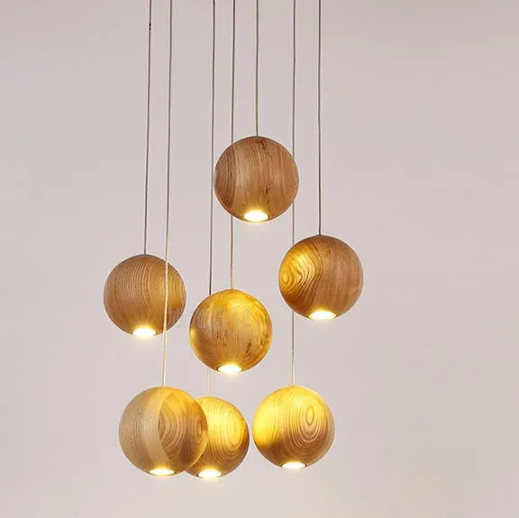 Nordic style solid wood ball chandelier hanging from ceiling with adjustable cord.