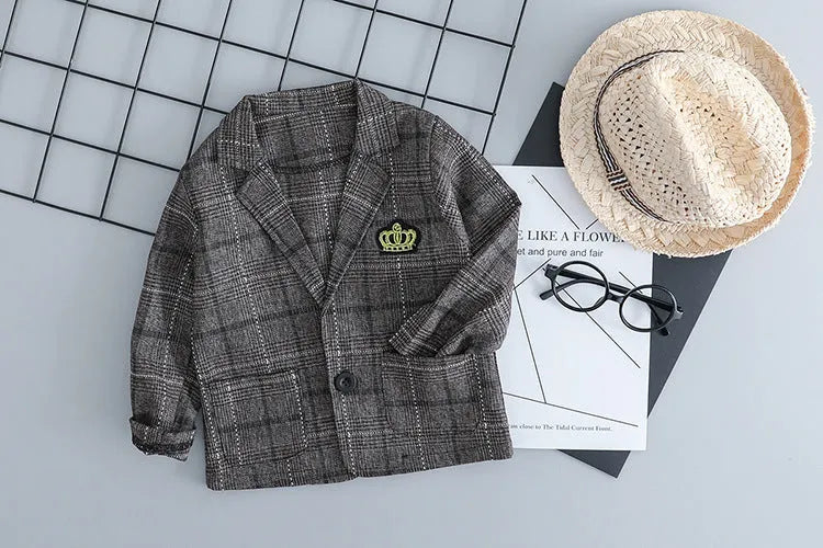 Grey three-piece children's suit with blazer, waistcoat, and trousers on a hanger.