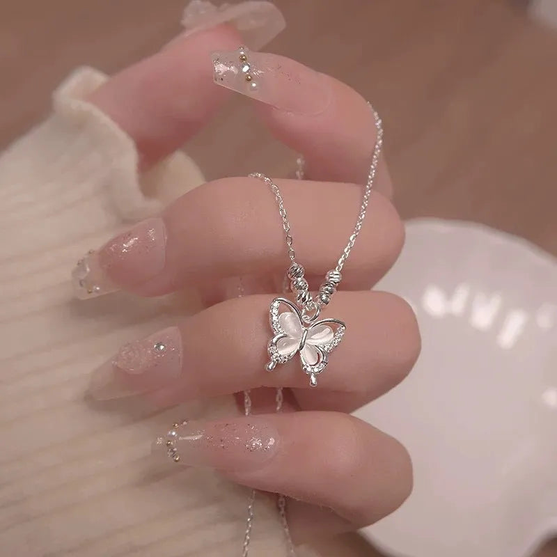 Square line opal butterfly pendant on a silver cross chain necklace