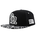 Adjustable black cotton baseball cap with embroidered lettering on the front, showing the dome crown and strap.