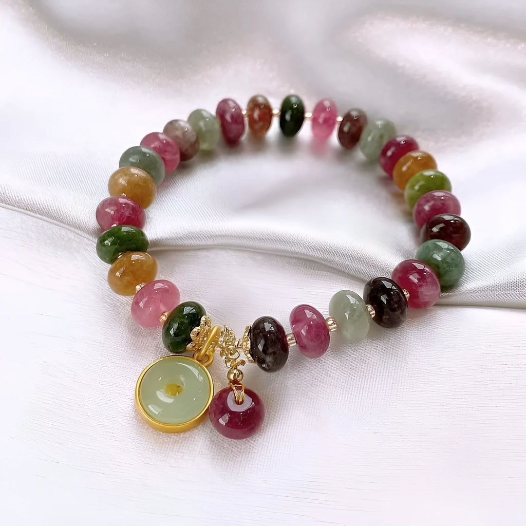 Close-up of a colourful tourmaline rabbit pendant bracelet with natural stone round beads.
