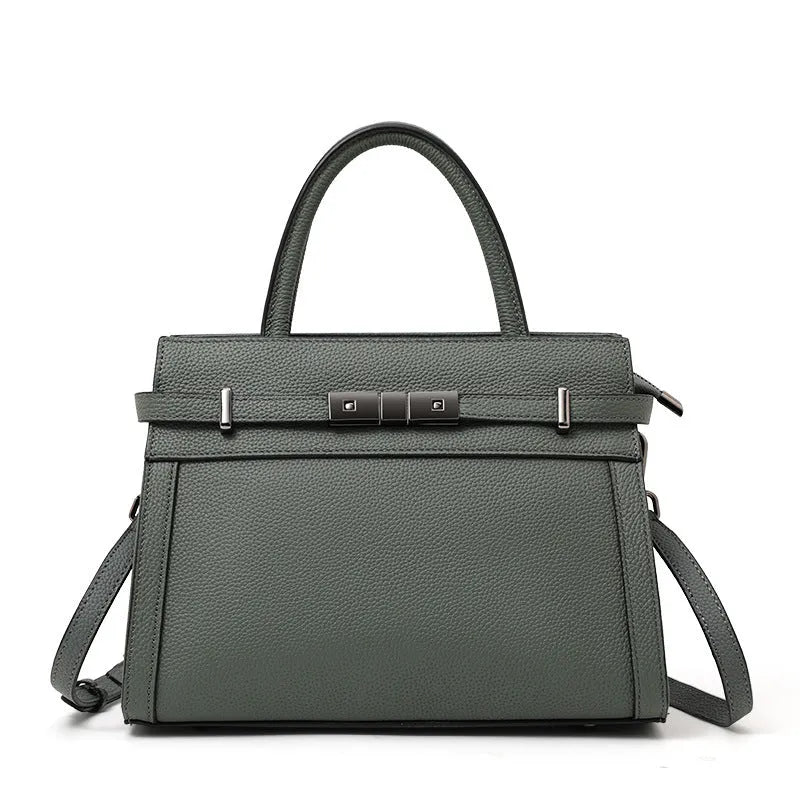 Women's black genuine leather crossbody clamshell handbag with multiple internal zip pockets.