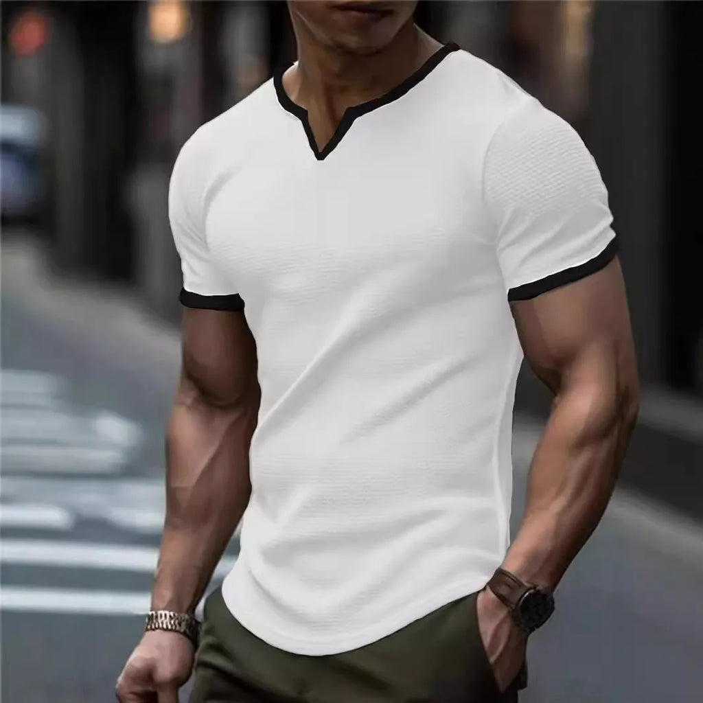 Colour-block waffle textured V-neck sports t-shirt in polyester on a size chart.