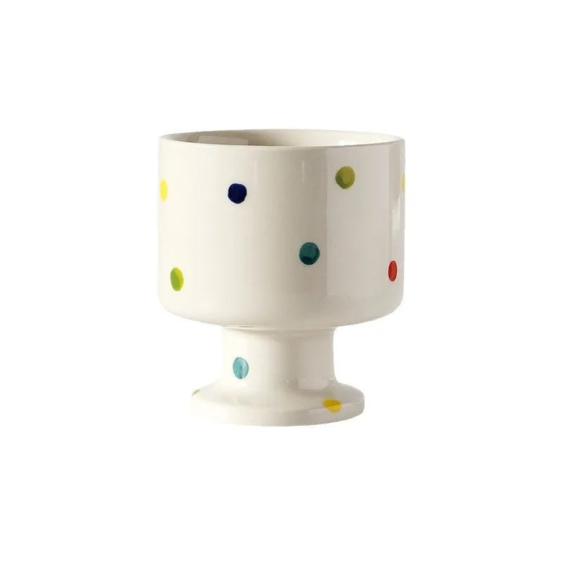 Hand-pinched irregular shaped solid colour ceramic mug on a table.