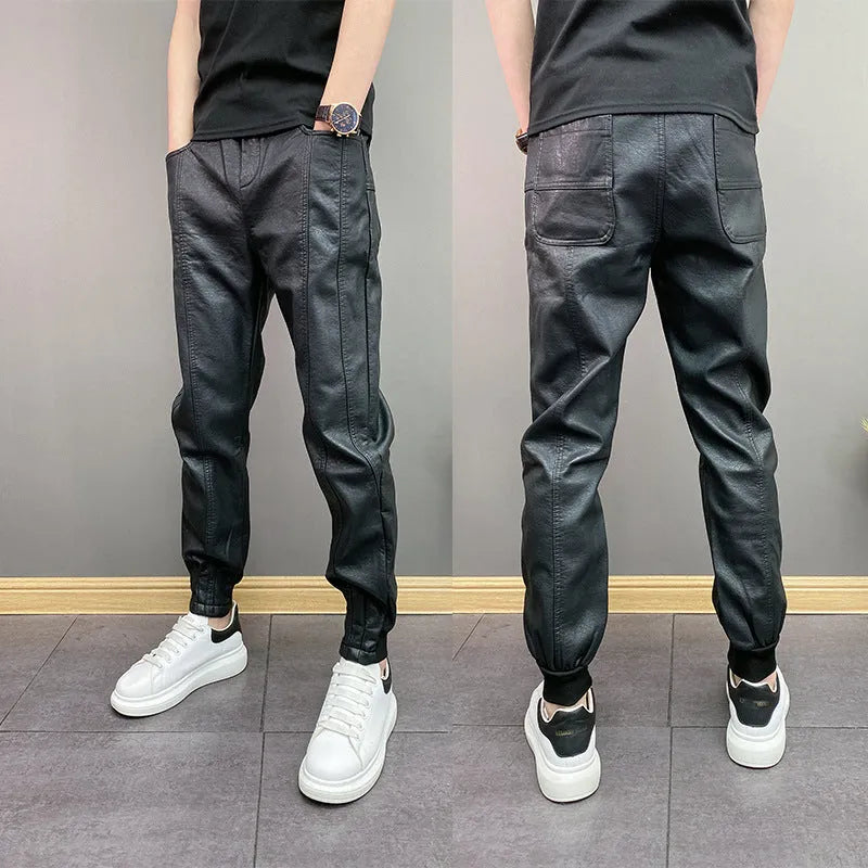 Black slim-fit waterproof motorcycle trousers in artificial leather with mid-rise waist and tapered leg