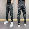 Black slim-fit waterproof motorcycle trousers in artificial leather with mid-rise waist and tapered leg