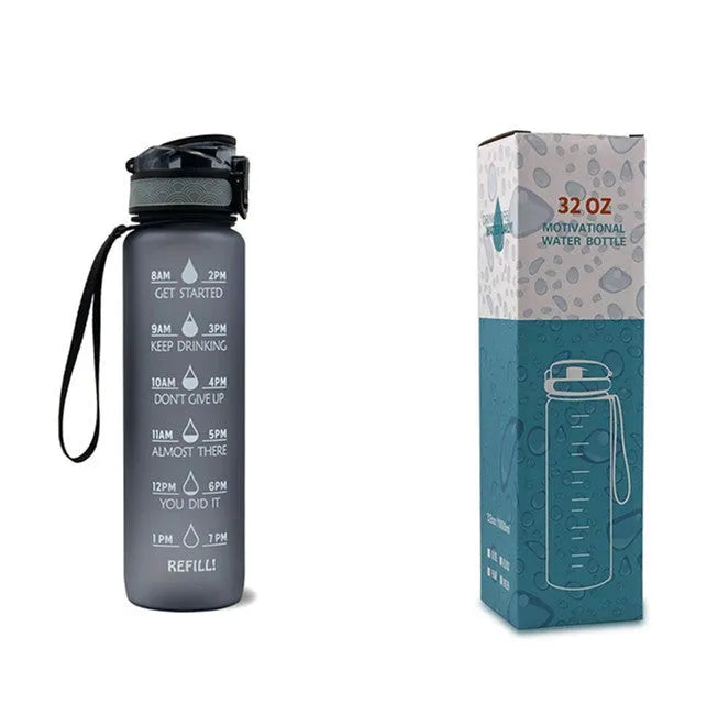 Blue-red gradient 1L Tritan water bottle with time markers and flip-top lid on a gym bag