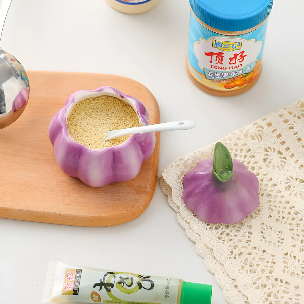 Ceramic onion seasoning jar with cover and spoon in modern simplicity style on a kitchen countertop
