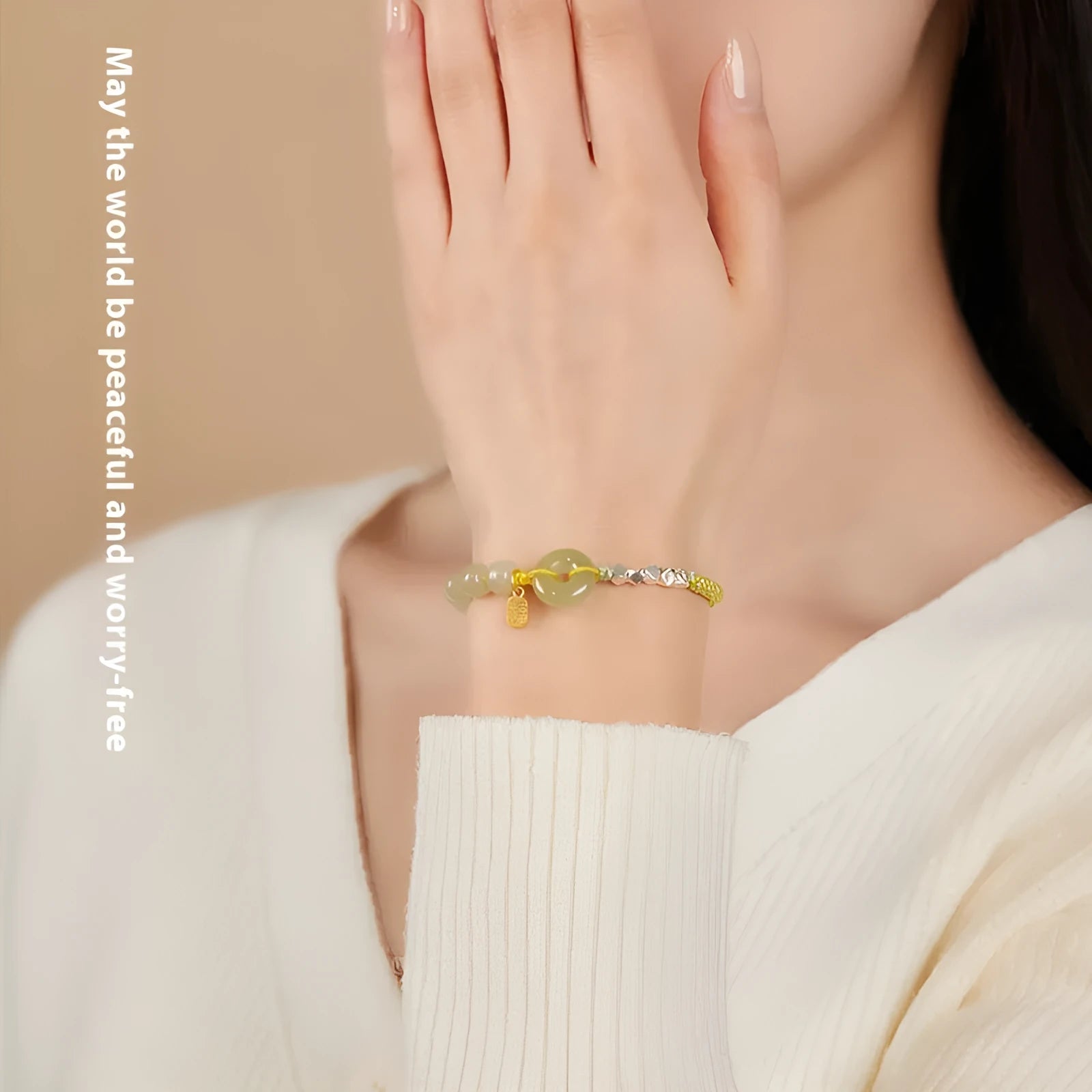 Woven bracelet with a natural Hetian jade flower charm and safety buckle in maple leaf yellow.