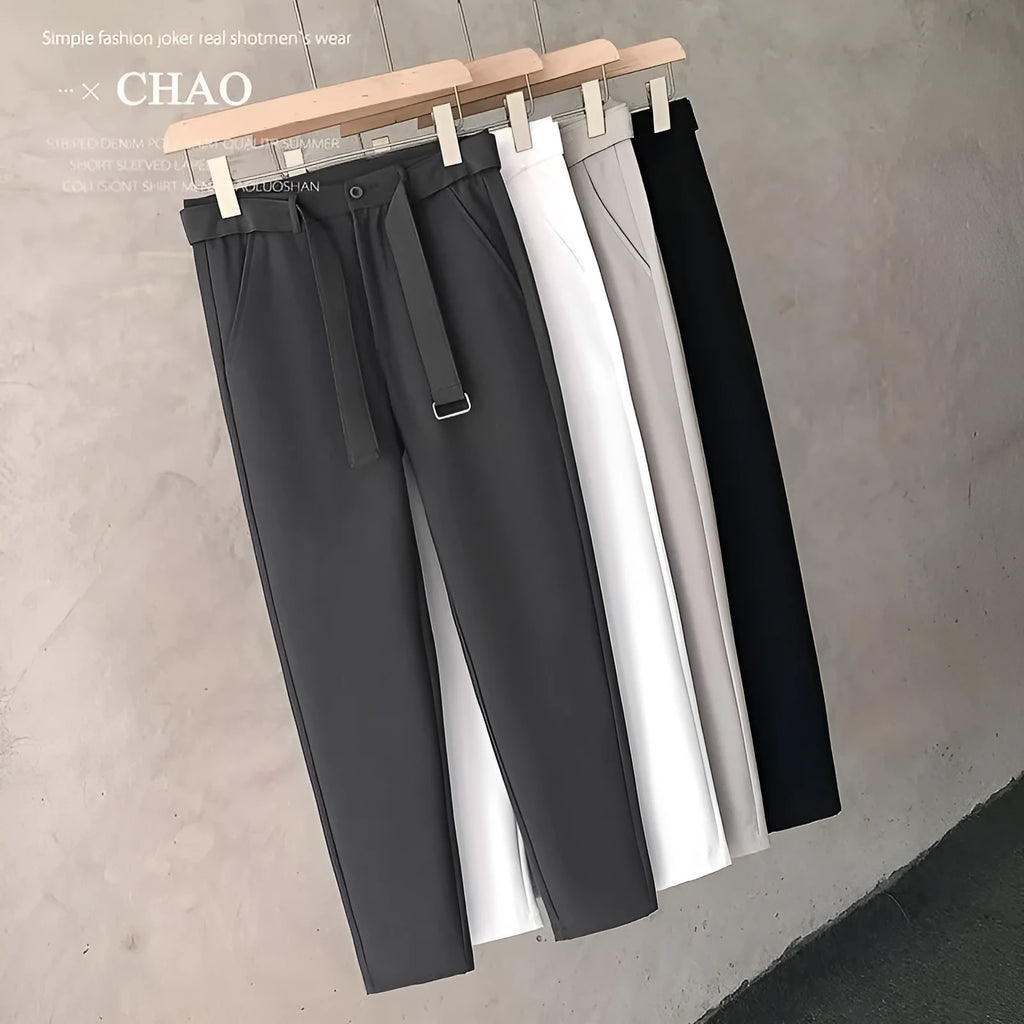 Boys slim straight wool trousers in tapered fit, shown in black, on a hanger.