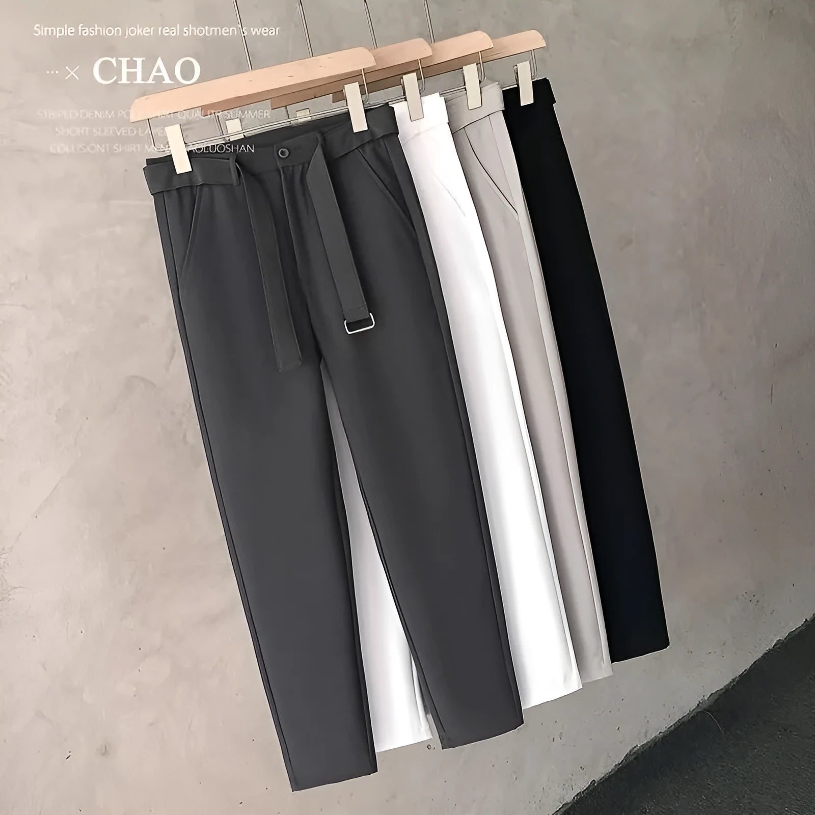 Boys slim straight wool trousers in tapered fit, shown in black, on a hanger.