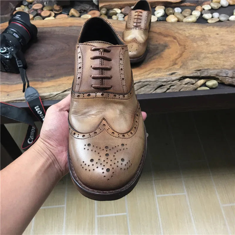 Light brown men's vintage casual leather shoes with hand-carved distressed detailing and a round toe.