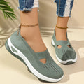 Women's low-top slip-on shoe in Flyknit mesh, shown in a choice of colours with a soft PVC sole.