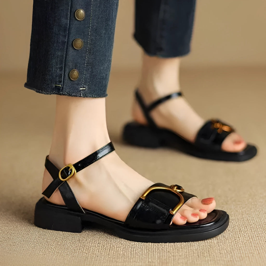 Women's brown leather sandals with a thick rubber sole and adjustable buckle strap.