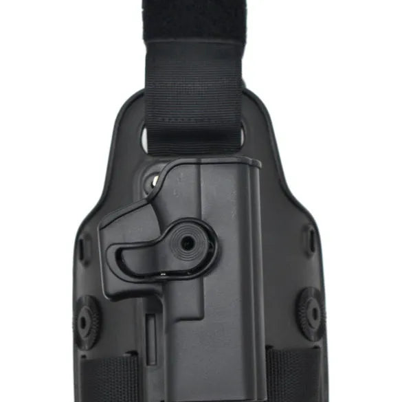 Tactical leg holster with waist plate and quick-pull plastic construction in outdoor setting