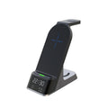 Black six-in-one wireless charging alarm clock showing phone, Apple Watch, and earphones on charging areas.