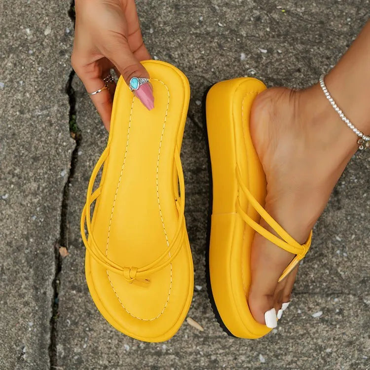 A pair of thick-soled flip-flops in a herringbone-patterned PU upper, shown in one of the available colours.