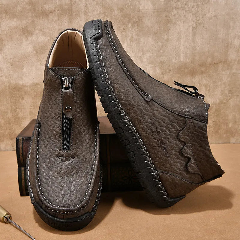 Men's black slip-on leather loafers with round toe and sewn sole on a rubber outsole.