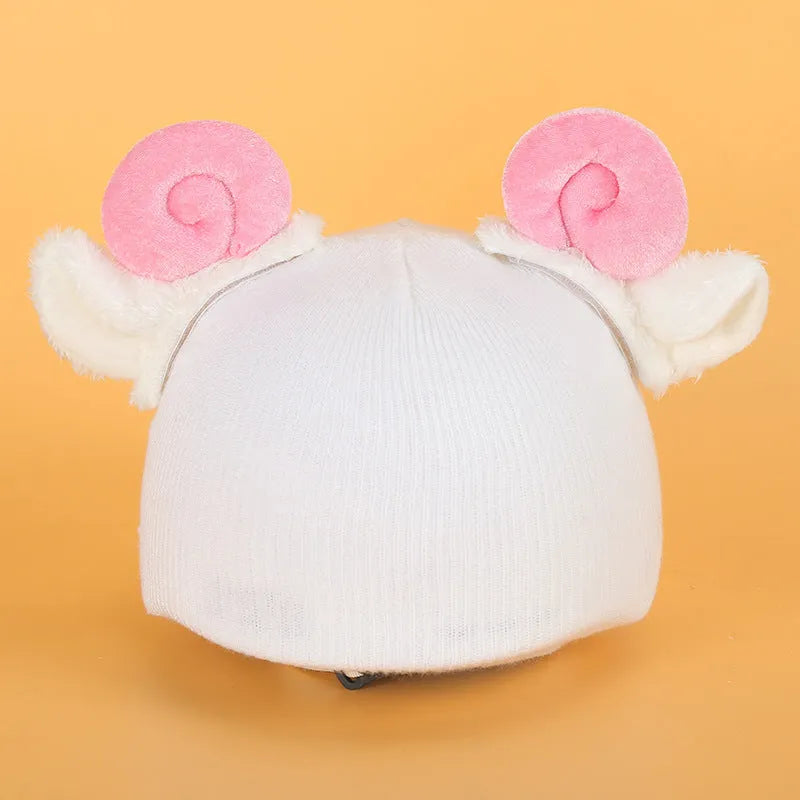 Soft plush fabric cartoon character decoration fitting on the peak of a black ski helmet.