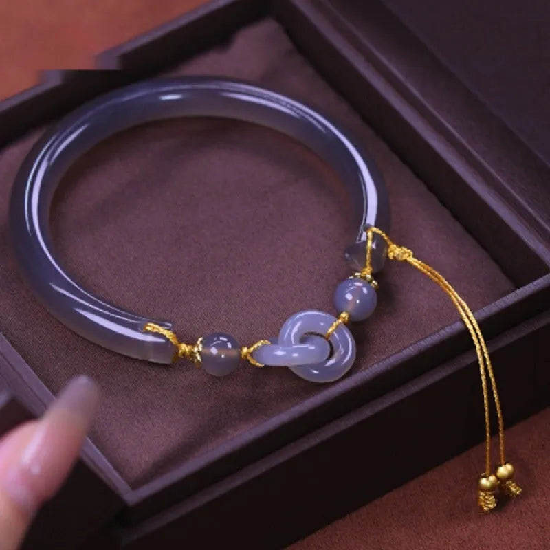 Grey retro-style half bracelet made from smoke purple agate with a visible metal ring buckle closure.