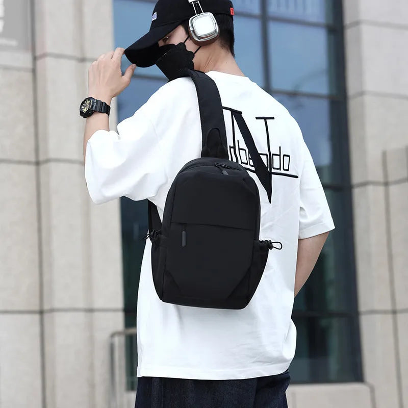 Grey waterproof polyester chest bag for men showing shoulder strap and main compartment